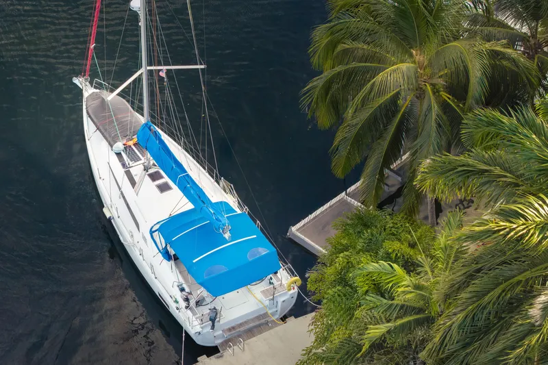 Slide: The Image of Aerial view of 2020 Beneteau Oceanis 46.1 yacht docked near palm trees. - 2
