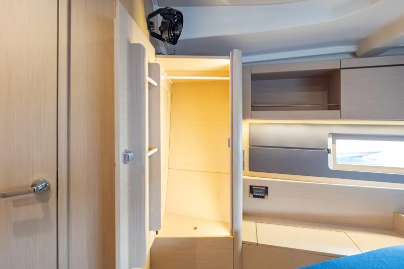 Slide: The Image of Interior of 2020 Beneteau Oceanis 46.1 yacht, featuring modern wood cabinetry and window. - 29