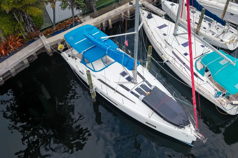Slide: The Image of 2020 Beneteau Oceanis 46.1 sailboat docked, featuring blue covers and sleek design. - 3