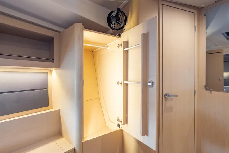 Slide: The Image of Interior of 2020 Beneteau Oceanis 46.1 yacht, featuring light wood cabinetry and storage space. - 30