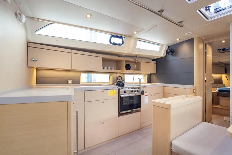 Slide: The Image of Modern kitchen interior of 2020 Beneteau Oceanis 46.1 yacht, featuring sleek cabinetry and appliances. - 32