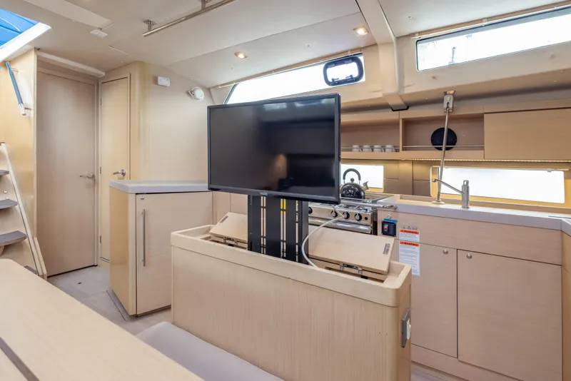 Slide: The Image of Modern interior of 2020 Beneteau Oceanis 46.1 yacht with TV and kitchen amenities. - 34