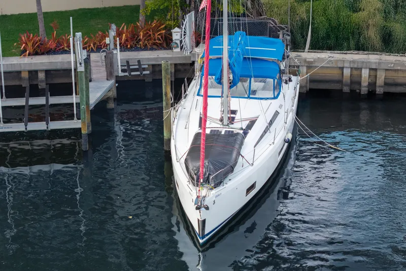 Slide: The Image of 2020 Beneteau Oceanis 46.1 yacht docked at marina, featuring blue canopy and sleek design. - 4