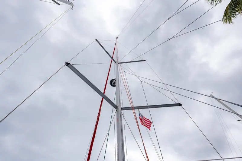 Slide: The Image of Mast of 2020 Beneteau Oceanis 46.1 sailboat with American flag against cloudy sky. - 7