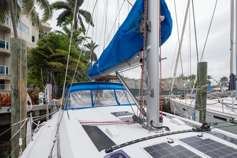 Slide: The Image of 2020 Beneteau Oceanis 46.1 sailboat docked, featuring blue sail cover and solar panels. - 9