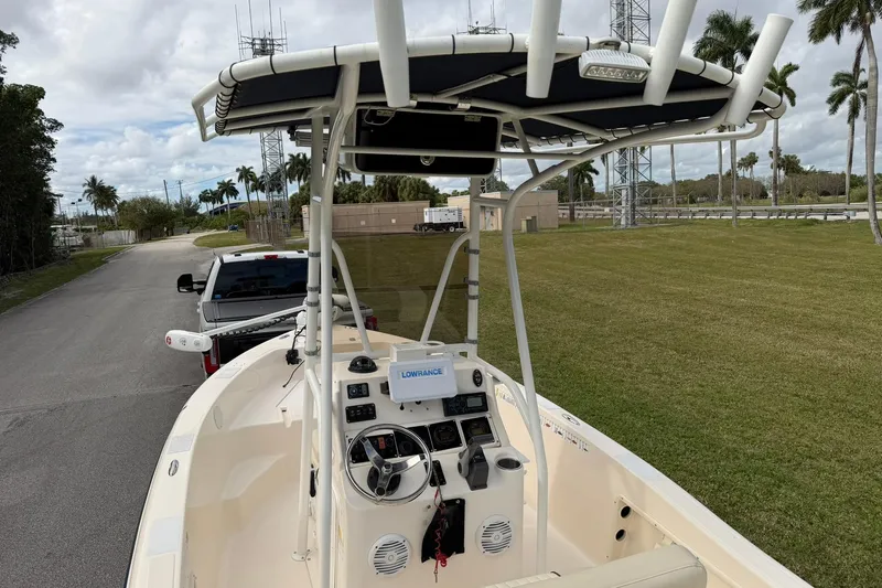 Slide: The Image of 2007 Key West 176 Sportsman CC boat with T-top and navigation equipment, parked on a grassy area. - 11