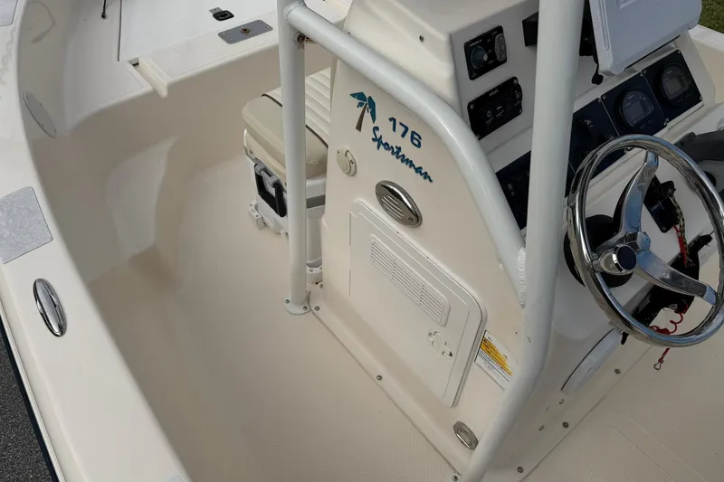 Slide: The Image of 2007 Key West 176 Sportsman CC boat interior with steering wheel and controls. - 13