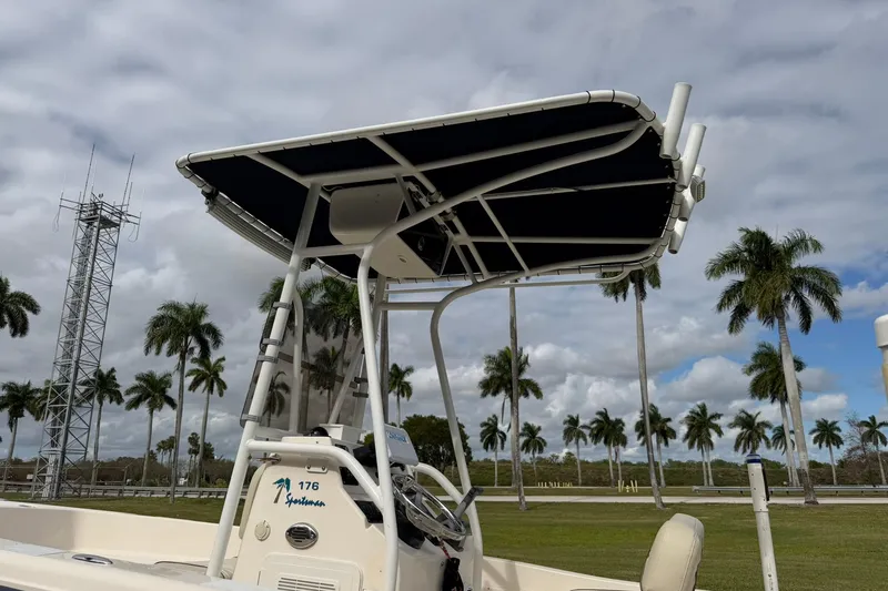Slide: The Image of 2007 Key West 176 Sportsman CC boat with T-top, palm trees in background. - 19