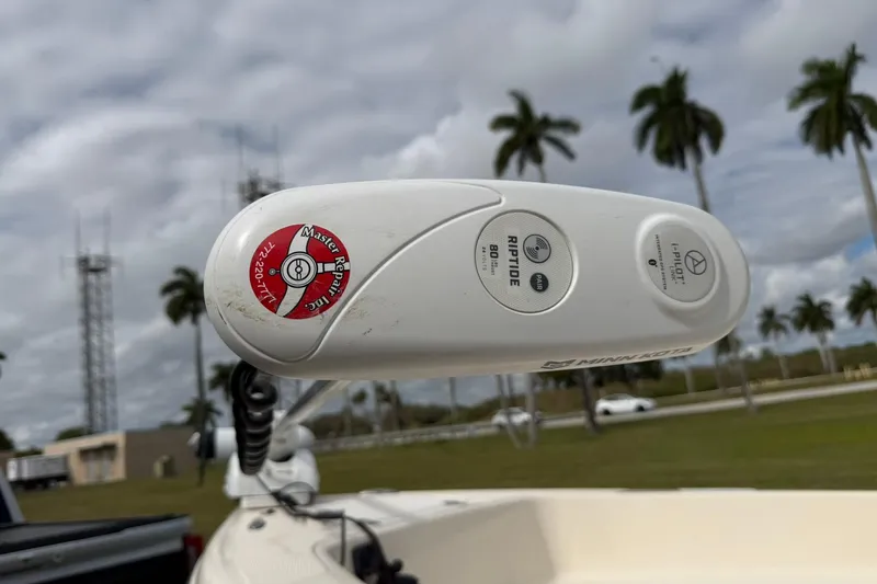 Slide: The Image of Minn Kota Riptide motor on 2007 Key West 176 Sportsman CC boat, palm trees in background. - 20
