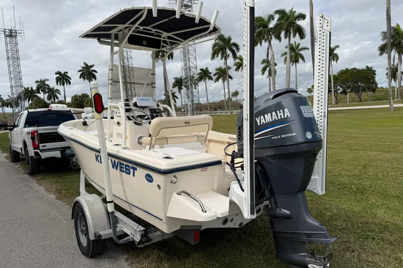 Slide: The Image of 2007 Key West 176 Sportsman CC boat with Yamaha engine on trailer, parked near palm trees. - 5