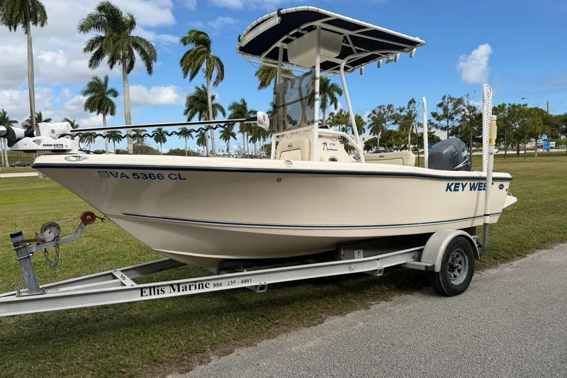 Slide: The Image of 2007 Key West 176 Sportsman CC boat on trailer, parked near palm trees. - 7