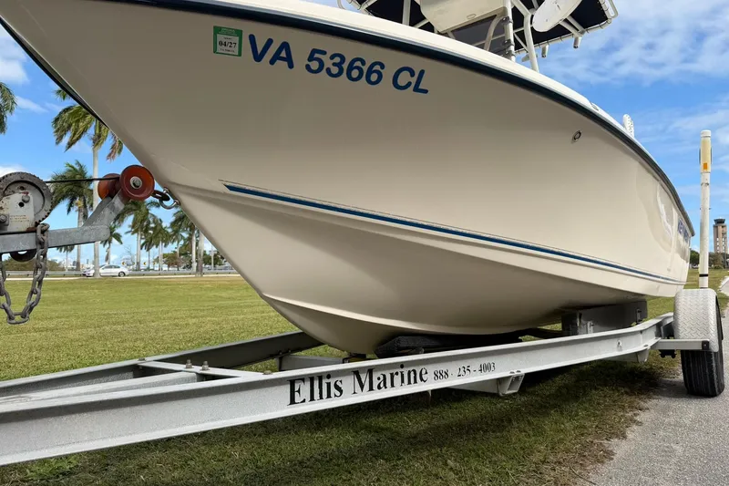 Slide: The Image of 2007 Key West 176 Sportsman CC boat on trailer, parked on grass with palm trees. - 8
