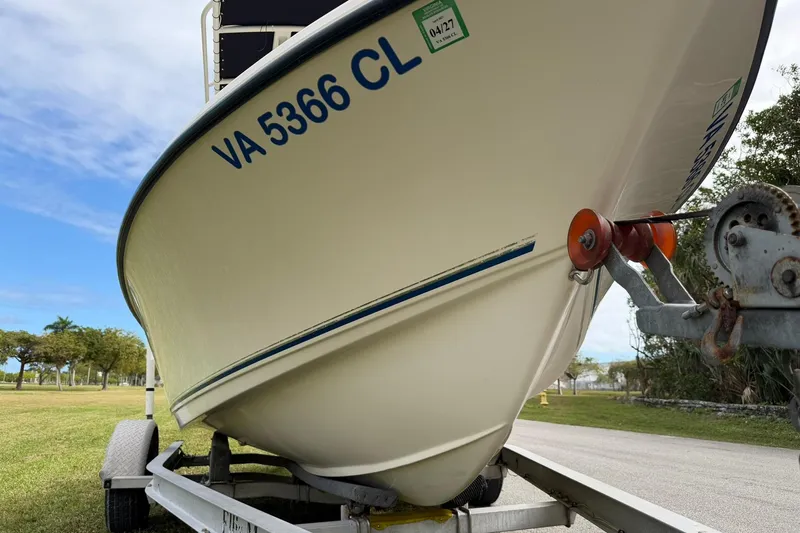 Slide: The Image of 2007 Key West 176 Sportsman CC boat on trailer, parked on grass. - 9