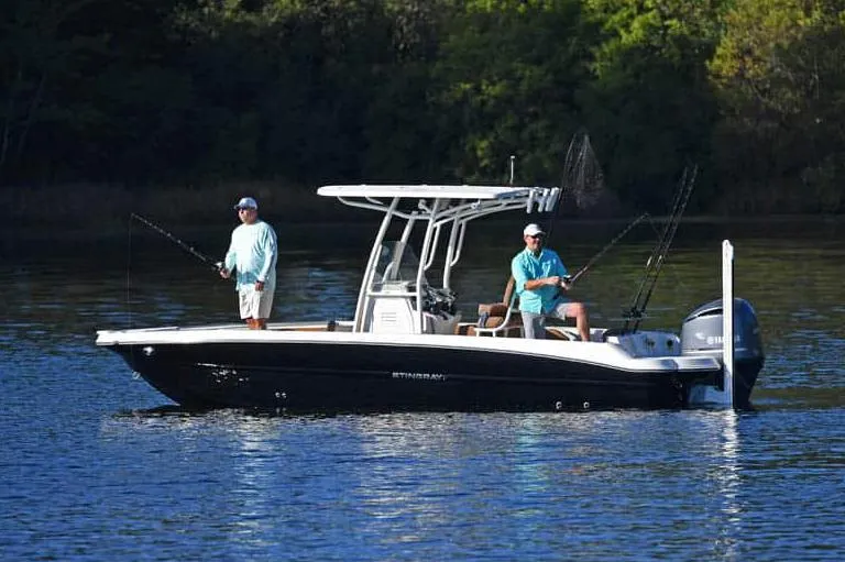 Slide: The Image of Manufacturer Provided Image: 2025 Stingray 236 CC boat with anglers fishing on calm water. - 13