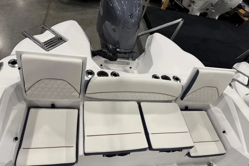 Slide: The Image of 2026 Stingray 236 CC boat interior with white cushioned seating and sleek design. - 4