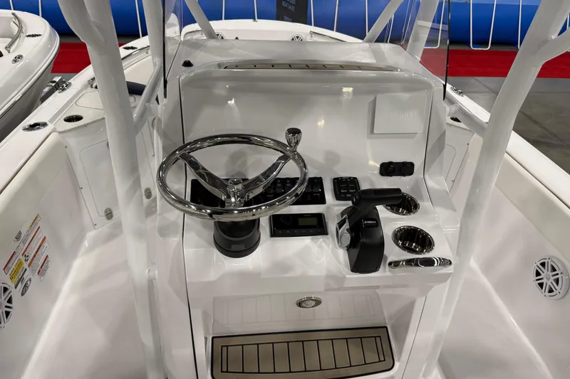 Slide: The Image of 2026 Stingray 236 CC boat console with steering wheel and controls. - 6