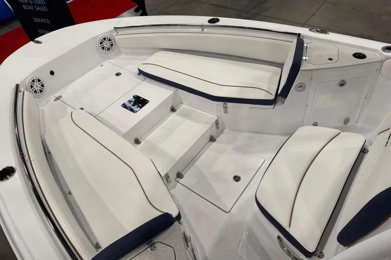Slide: The Image of 2026 Stingray 236 CC boat interior with white cushioned seating and storage compartments. - 8