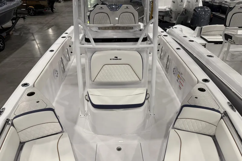 Slide: The Image of 2026 Stingray 236 CC boat interior with white seating and modern design. - 9