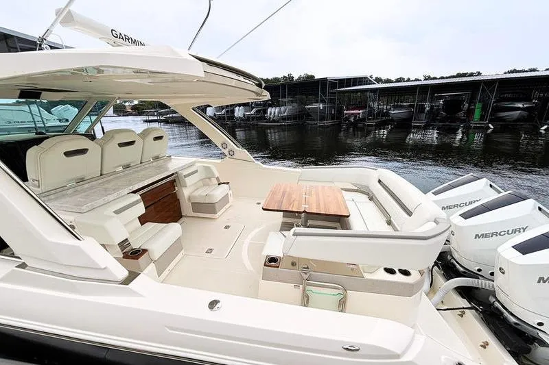 Slide: The Image of Luxurious 2025 Tiara Yachts 38 LS with spacious seating and modern amenities docked by the water. - 14