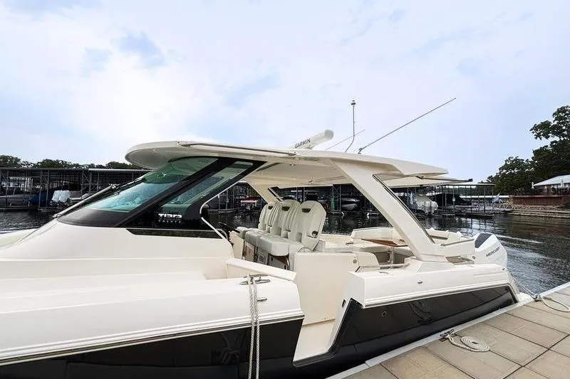 Slide: The Image of 2025 Tiara Yachts 38 LS luxury boat docked at marina, showcasing sleek design. - 20