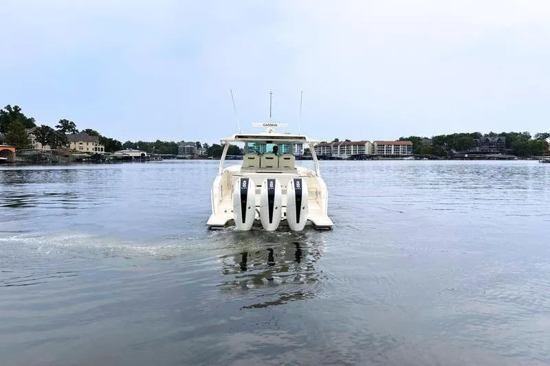 Slide: The Image of 2025 Tiara Yachts 38 LS cruising on a calm lake with triple engines. - 5