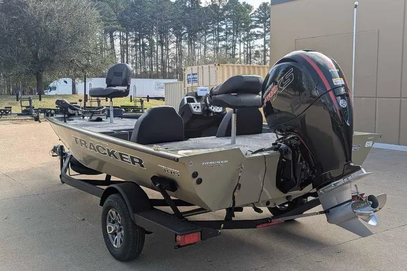 Slide: The Image of 2026 Tracker Pro Team 195 boat with powerful outboard motor, parked outdoors. - 10