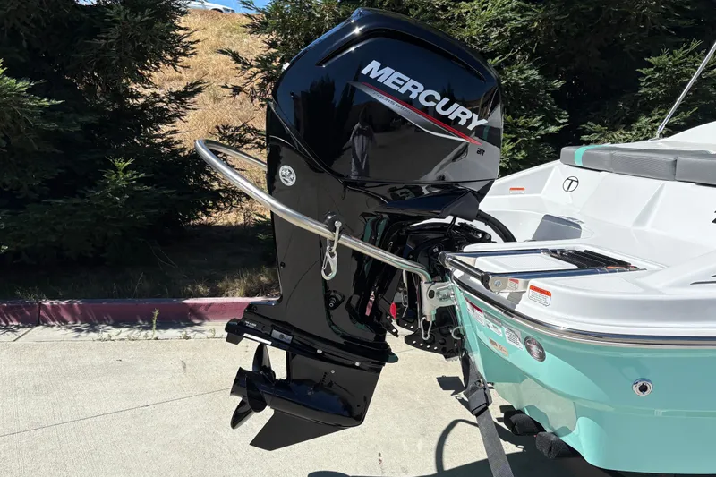 Slide: The Image of 2026 Tahoe T16 boat with Mercury outboard motor in a sunny outdoor setting. - 12
