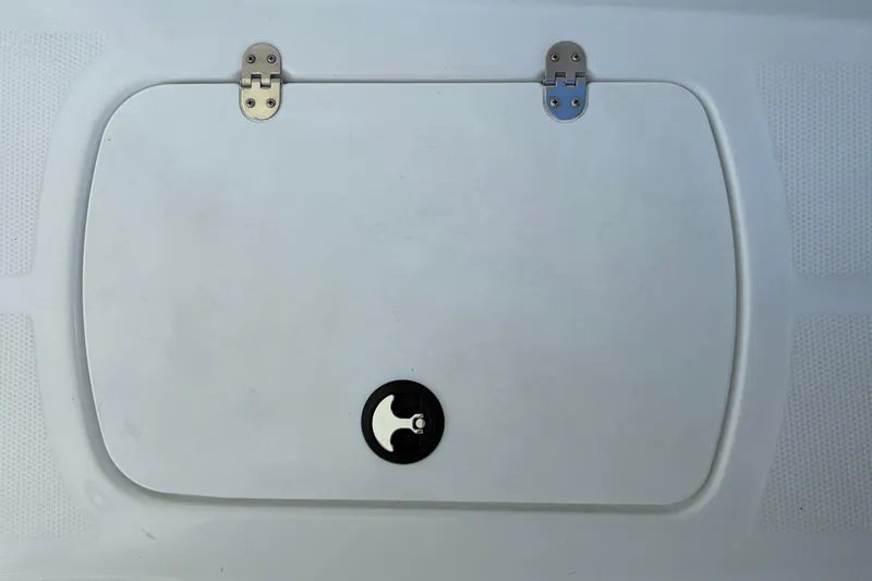 Slide: The Image of 2026 Tahoe T16 boat hatch with metal hinges and circular handle. - 34