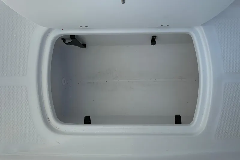 Slide: The Image of Open storage compartment in 2026 Tahoe T16 boat, featuring a clean, white interior. - 33