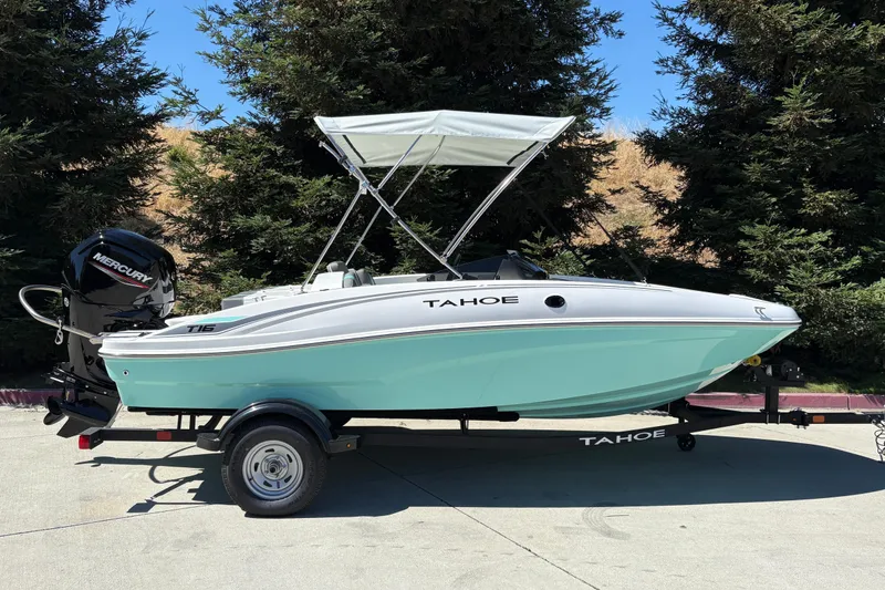 The Image of 2026 Tahoe T16 boat with Mercury engine on trailer, parked outdoors. - 0