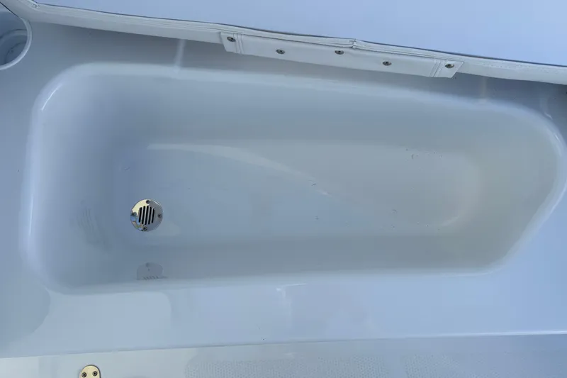Slide: The Image of Interior view of a 2026 Tahoe T16 boat compartment with drain. - 37