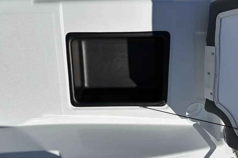 Slide: The Image of 2026 Tahoe T16 boat storage compartment with black interior and white exterior. - 29