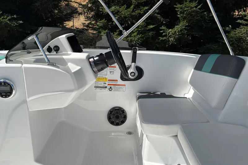 Slide: The Image of 2026 Tahoe T16 boat interior with steering wheel, dashboard, and seating. - 18