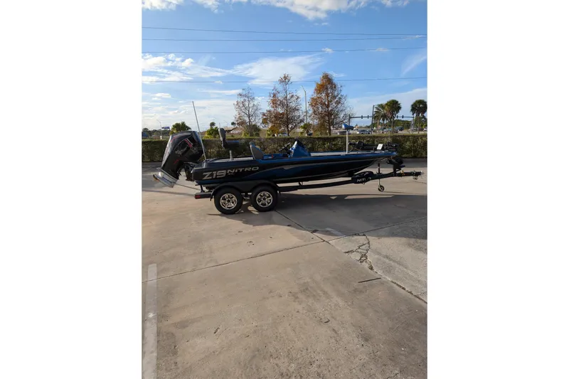 The Image of 2026 Nitro Z19 XL Pro boat on trailer, parked outdoors under clear sky. - 0