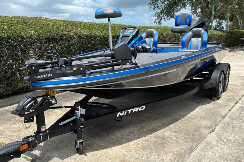Slide: The Image of 2026 Nitro Z19 XL Pro boat with Garmin equipment on a trailer, parked outdoors. - 1