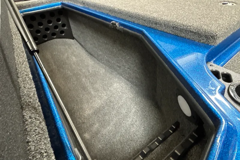 Slide: The Image of Interior view of 2026 Nitro Z19 XL Pro boat storage compartment with blue trim. - 26
