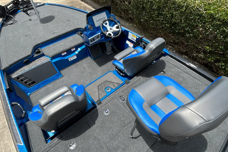 Slide: The Image of 2026 Nitro Z19 XL Pro boat interior with blue and gray seating, Garmin display. - 11