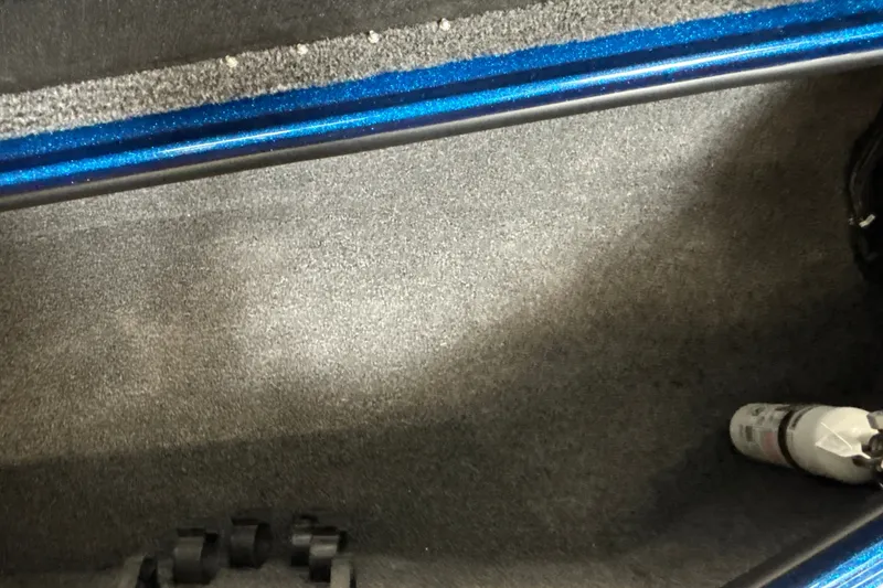 Slide: The Image of Interior of a 2026 Nitro Z19 XL Pro boat, featuring blue trim and carpeted flooring. - 29