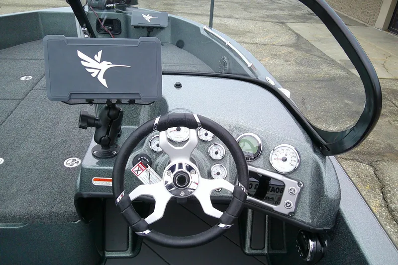 Slide: The Image of 2026 Nitro ZV19 Sport boat dashboard with steering wheel and control panel. - 8