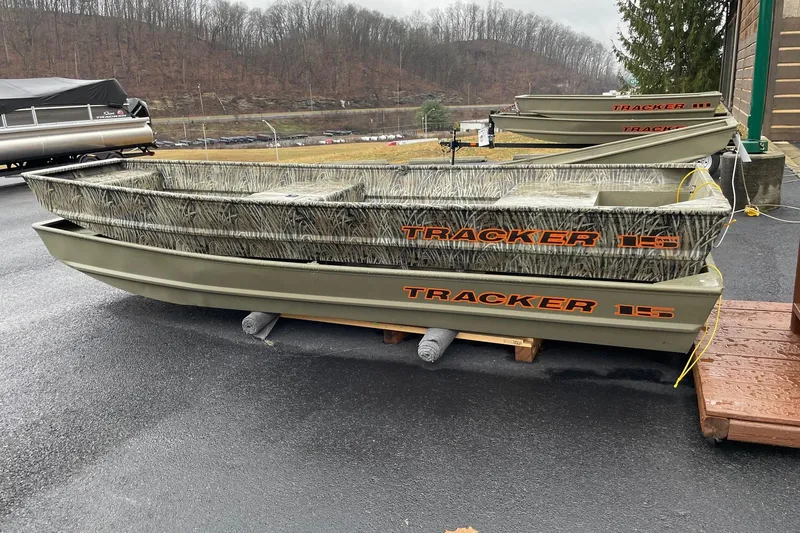 The Image of 2026 Tracker Grizzly 15 Jon boat on display, featuring camouflage design. - 0
