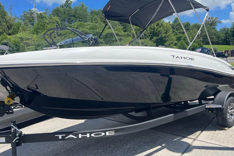 Slide: The Image of 2026 Tahoe T18 boat on trailer, sleek design, black and white finish, outdoor setting. - 69