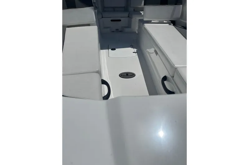 Slide: The Image of 2026 Tahoe T18 boat interior with white seating and storage compartments. - 4