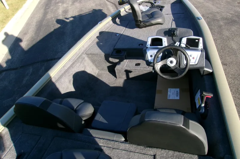 Slide: The Image of 2026 Tracker Pro Team 175 Crappie Edition boat interior with steering wheel and seating. - 52