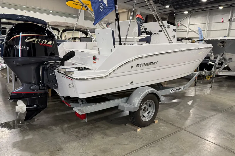 The Image of 2026 Stingray 173 CC boat on trailer with Yamaha outboard motor in showroom. - 0