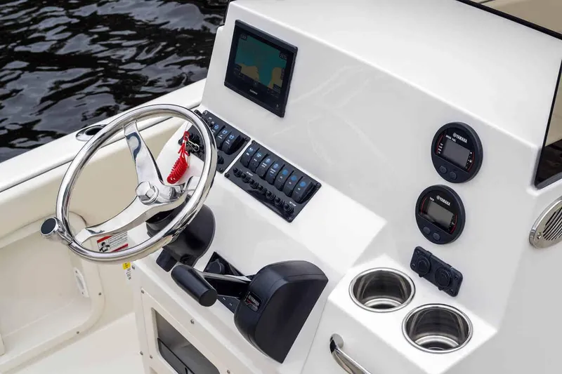 Slide: The Image of Manufacturer Provided Image: 2025 Stingray 173 CC boat dashboard with steering wheel and control panel. - 11
