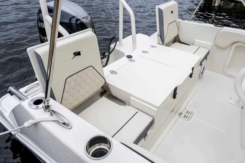 Slide: The Image of Manufacturer Provided Image: 2025 Stingray 173 CC boat interior with cushioned seating and storage compartments. - 12