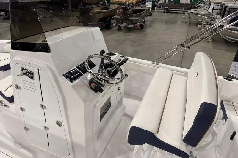 Slide: The Image of 2026 Stingray 173 CC boat interior with steering wheel and seating. - 3