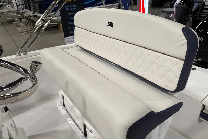 Slide: The Image of 2026 Stingray 173 CC boat interior with white cushioned seating and chrome steering wheel. - 4