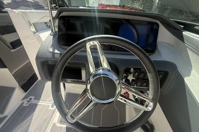 Slide: The Image of 2023 Regal LS4 Surf boat steering wheel and dashboard with modern controls. - 11