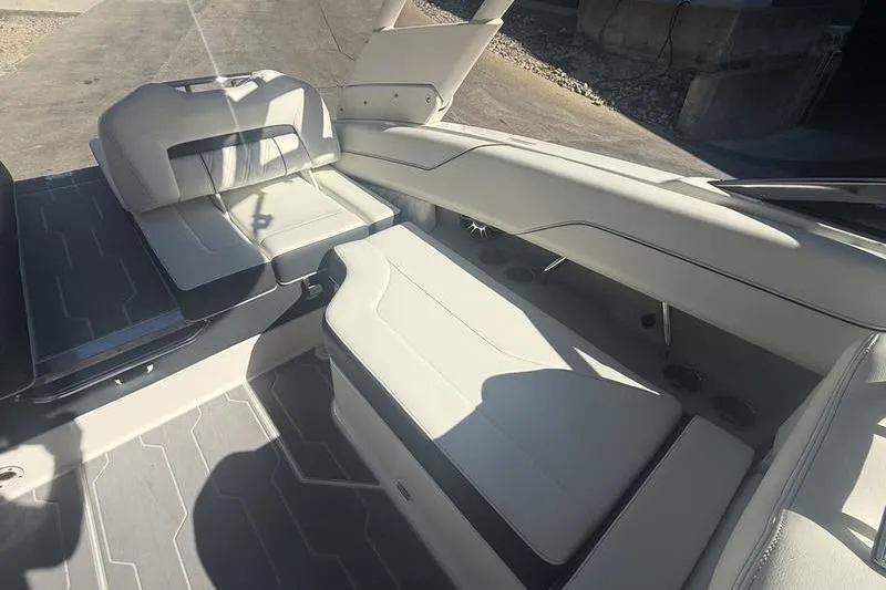 Slide: The Image of 2023 Regal LS4 Surf boat interior with sleek white seating and modern design. - 13